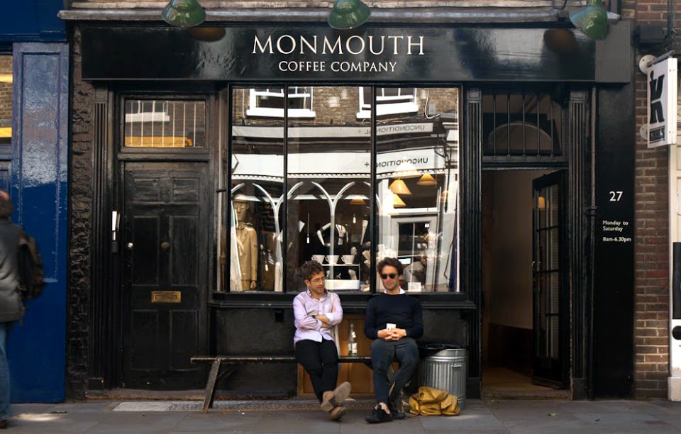A perfectly poured Monmouth espresso macchiato alongside a fresh buttery croissant